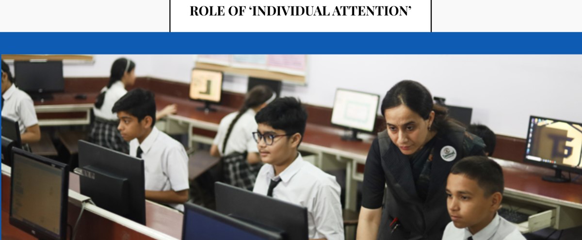 Students learning with a teacher in school computer lab
